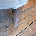 French Nursery chair. Detail of brown beechwood turned leg.